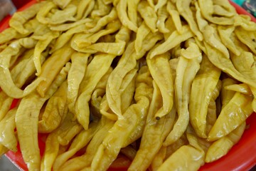Close up of pickled chili peppers on sale at local famers market.
