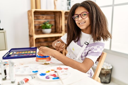 African american girl smiling confident drawing ceramic at art school