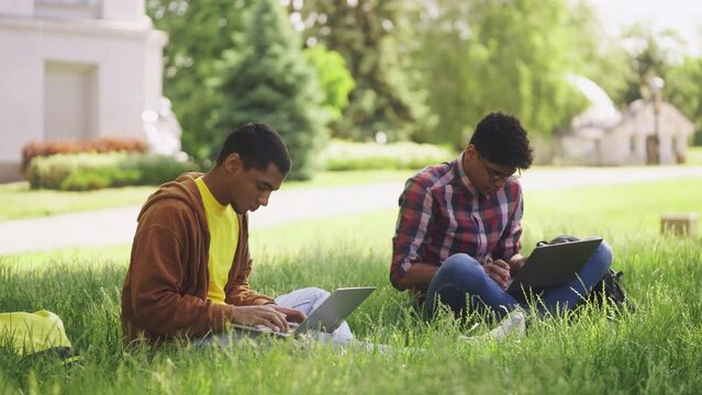 Male students studying on laptops on college campus, online education, gadgets