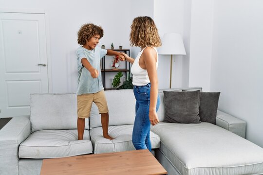 Mother And Son Smiling Confident Dancing At Home