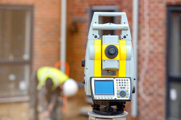 Surveyor optical equipment  tacheometer or theodolite on construction site close-up with selective focus and blurred background