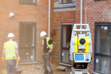 Surveyor optical equipment  tacheometer or theodolite on construction site close-up with selective focus and blurred background