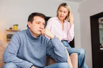 Angry middle aged couple arguing shouting blaming each other of problem