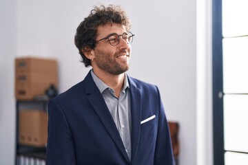 Young hispanic man business worker smiling confident standing at office