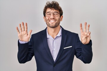 Hispanic business man wearing glasses showing and pointing up with fingers number eight while smiling confident and happy.
