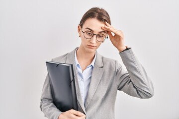 Young caucasian woman wearing business clothes and glasses worried and stressed about a problem with hand on forehead, nervous and anxious for crisis