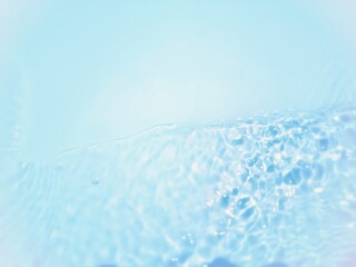 Defocus blurred transparent blue colored clear calm water surface texture with splash, bubble. Shining blue water ripple background. Surface of water in swimming pool. Blue bubble water shining.