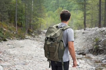 Faceless portrait of man tourist hiking in the forest. Adventure and active lifestyle in nature