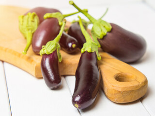 Fresh eggplant on a wooden background close-up