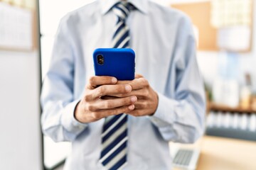 Businessman using smartphone working at the office.