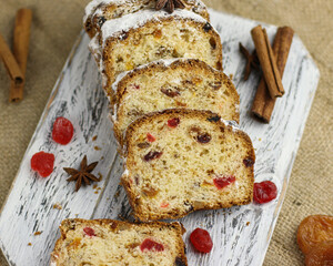 Stollen slice on table. Christmas bread with cinnamon and cherry