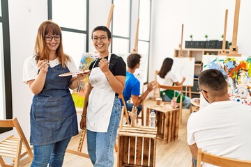 Group of people smiling happy drawing at art studio.