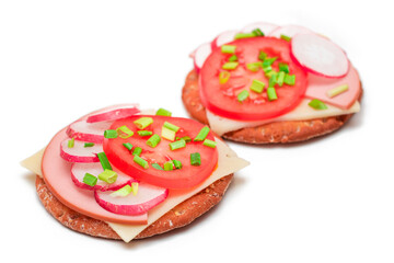 Crispy Cracker Sandwiches with Tomato, Sausage, Cheese, Green Onions and Radish - Isolated on White. Easy Breakfast. Diet Food. Quick and Healthy Sandwiches. Crispbread with Tasty Filling - Isolation