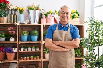 Middle age grey-haired man florist smiling confident standing with arms crossed gesture at florist