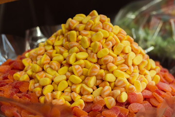 huge pile of yellow jelly sweets in a candy shop