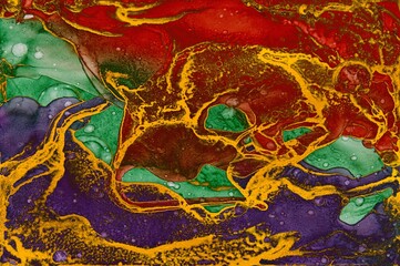 Painted with golden dust and other three colors on Alcohol ink fluid abstract texture fluid art with gold glitter and liquid.