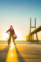 Obraz premium BMX Tricks For Beginners. A teenager bike racing rider in a skate park on a pump track.