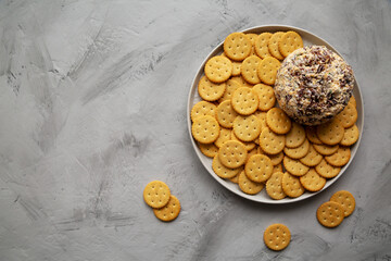 Homemade Cheese Ball with Cream Cheese and Green Onions on a Plate, top view. Flat lay, overhead, from above.