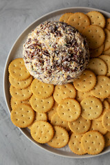 Homemade Cheese Ball with Cream Cheese and Green Onions on a Plate, top view. Flat lay, overhead, from above.