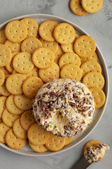 Homemade Cheese Ball with Cream Cheese and Green Onions on a Plate, top view. Flat lay, overhead, from above.