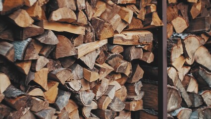 Stacked Chopped Logs of Wood For Fireplace Stored Outdoors before Winter Season in Simple Metal...