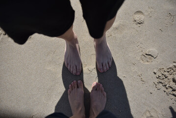 Legs of a woman on the sandy beach. Happy feet in tropical paradise