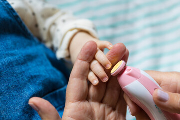 Parent trimming baby's nails