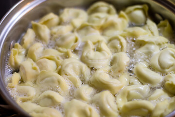 Boiling ravioli in a pot on a stove