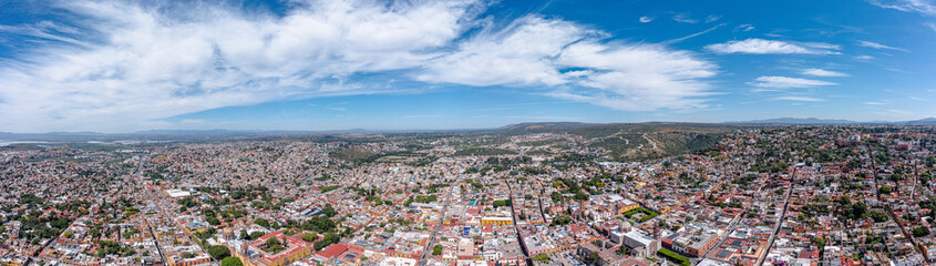 Fototapeta na wymiar Aerial: panoramic cityscape and landscape in San Miguel de Allende. Drone view 