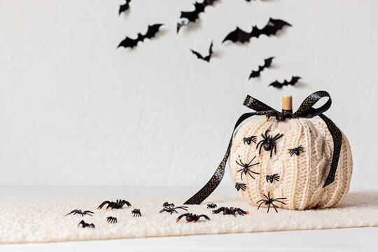 Modern interior decoration for halloween celebration with handmade knit pumpkin, spiders