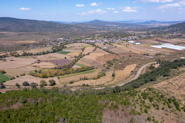 Aerial: panorama view of the mountains and a small village. Drone view