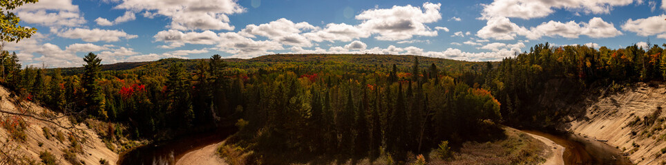 Arrowhead provincial park in the fall season with about half the trees turning colour