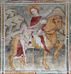 San Martino dona il mantello. Affresco nella chiesetta dei Santi Ippolito e Cassiano a Castel Tesino (Trentino)