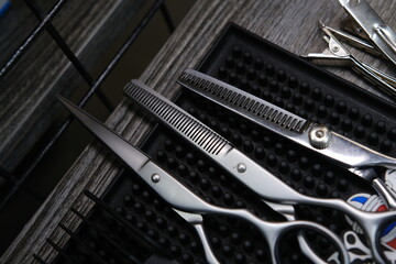 Vintage barber shop tools on old wooden background and rubber mat