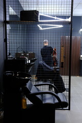 Stylish Vintage Barber Chairs In Black And Grey Interior. Barbershop Theme, Barbershop and barber working with client