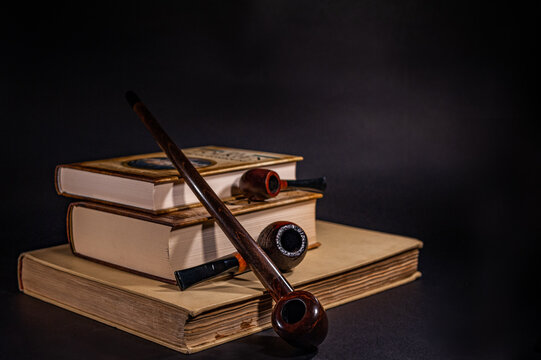 Tobacco pipes lying on the books