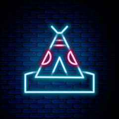 Glowing neon line Traditional indian teepee or wigwam icon isolated on brick wall background. Indian tent. Colorful outline concept. Vector © vector_v