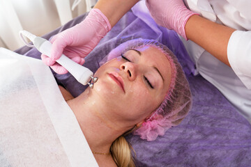 Micro current therapy. Cosmetology beauty skincare procedure by beautician. 