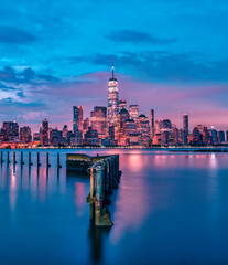 city skyline at sunrise beautiful New York Manhattan sky colors river water reflections lights...