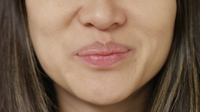 Close shot of female mouth talking directly to camera 