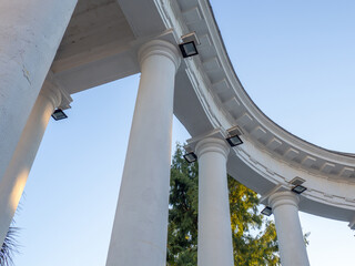 White arch and lanterns on it. Architectural ensemble. Decorative building. Arch at the entrance to...