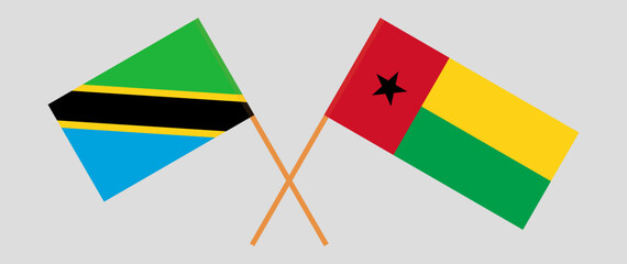 Crossed flags of Tanzania and Guinea-Bissau. Official colors. Correct proportion