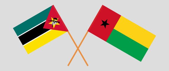 Crossed flags of Mozambique and Guinea-Bissau. Official colors. Correct proportion