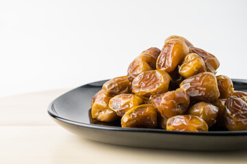Delicious Sukari dates ( kurma sukari ) Much sought after during the month of Ramadan as a dish to break the fast, ramadhan kareem, in white background, empty space, copy space