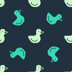 Green and beige Rubber duck icon isolated seamless pattern on blue background. Vector