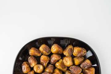 Delicious Sukari dates ( kurma sukari ) Much sought after during the month of Ramadan as a dish to break the fast, ramadhan kareem, in white background, empty space, copy space