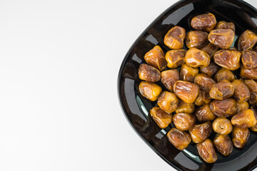 Delicious Sukari dates ( kurma sukari ) Much sought after during the month of Ramadan as a dish to break the fast, ramadhan kareem, in white background, empty space, copy space