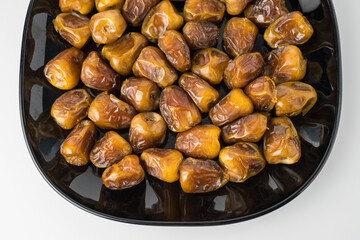 Delicious Sukari dates ( kurma sukari ) Much sought after during the month of Ramadan as a dish to break the fast, ramadhan kareem, in white background, empty space, copy space