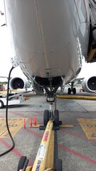 Boeing 737 Max 9 nose landing gear and tow bar attached.