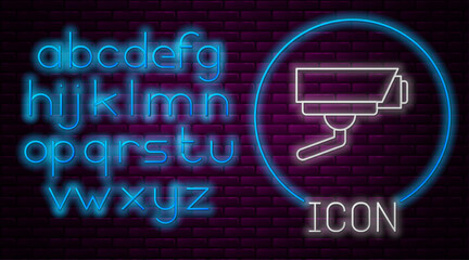 Glowing neon line Security camera icon isolated on brick wall background. Neon light alphabet. Vector